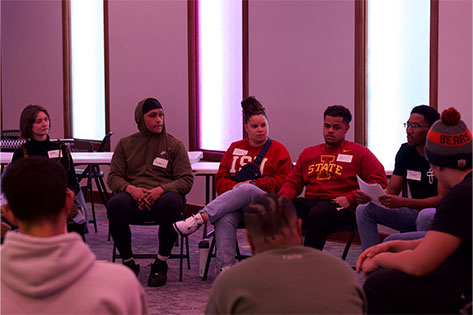 young adults sitting in a circle talking